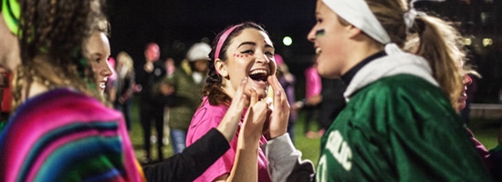 Students giving high fives after Powderpuff football game